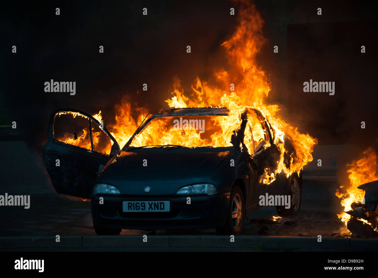 Car well alight on fire petrol bomb flames Stock Photo