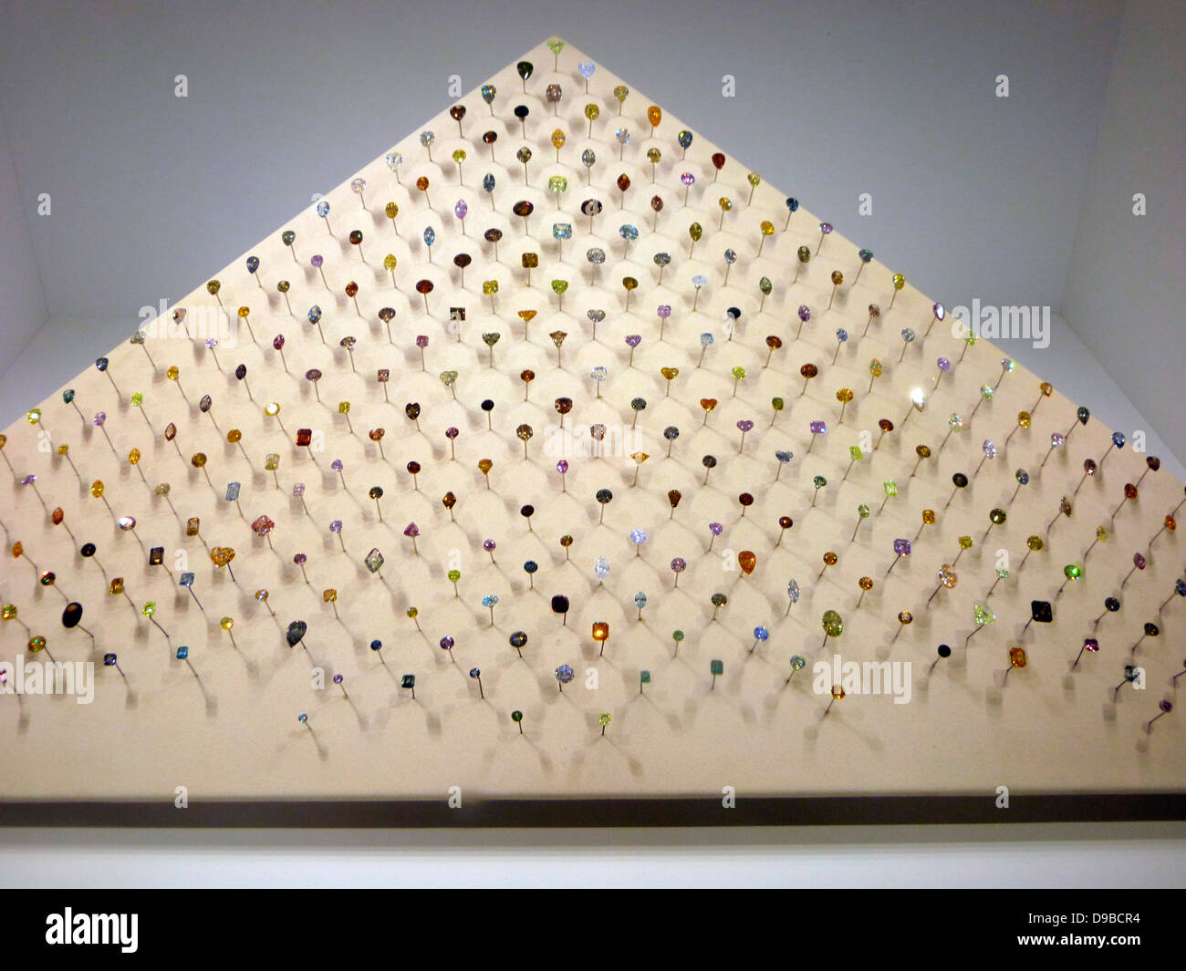 Aurora Pyramid of Hope.  This stunning array of 296 naturally coloured diamonds has taken more than 25 years to collect.  It shows the full range of colours in which diamonds can be found.  Under ultraviolet light you can see another, hidden quality.  The diamonds glow, showing colours quite different from the ones you see in normal light. Stock Photo