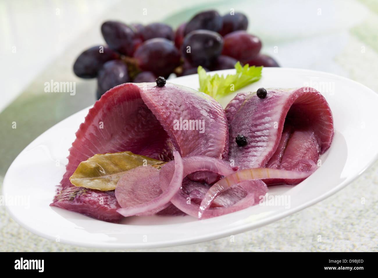Herring in sherry vinegar with onions on plate, close up Stock Photo