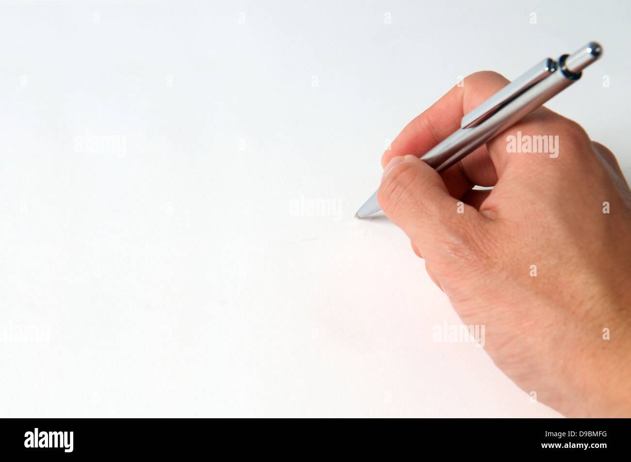 Hand with pen writing on blank paper Stock Photo