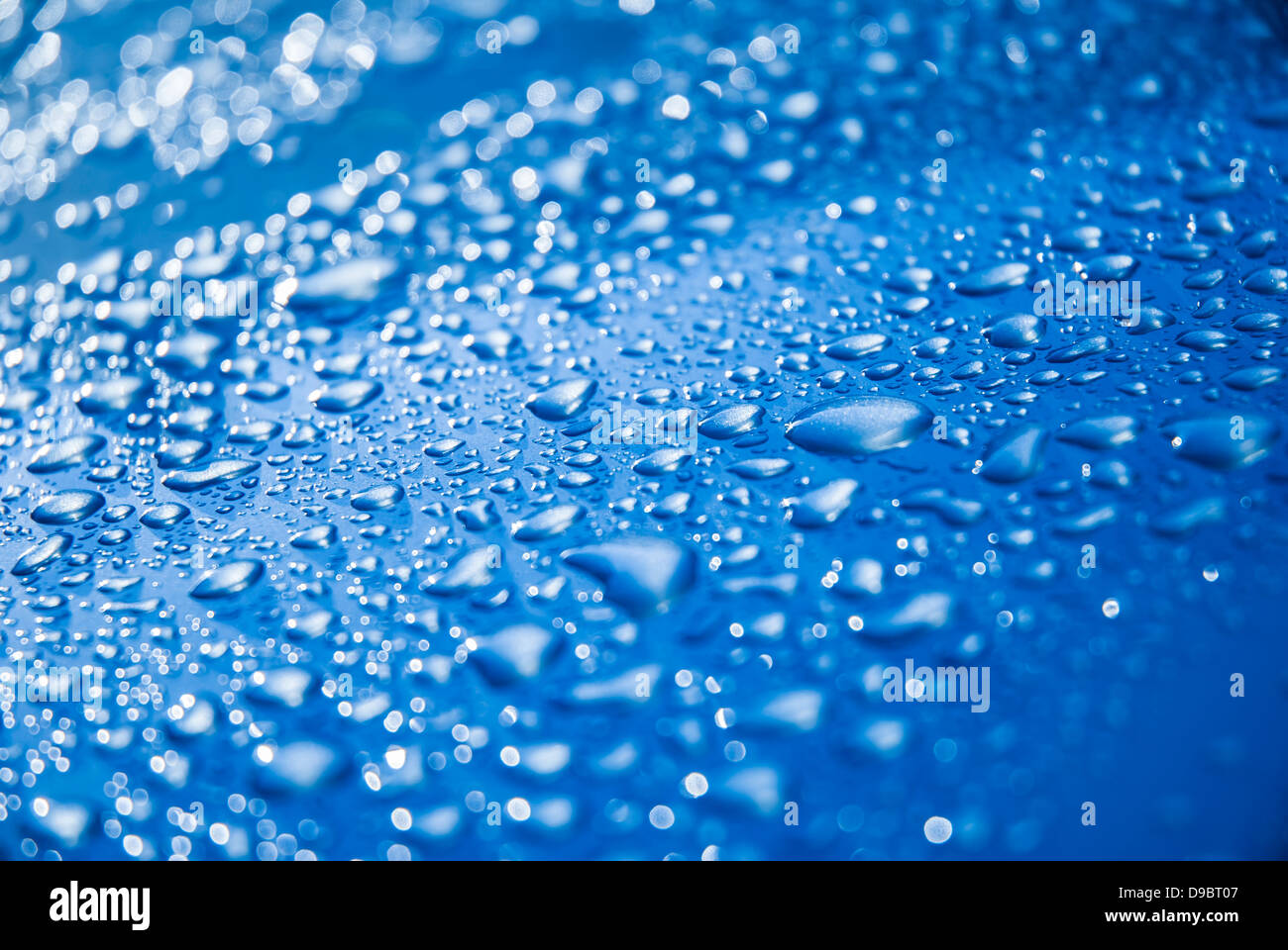 Water droplets on a smooth, blue surface Stock Photo - Alamy