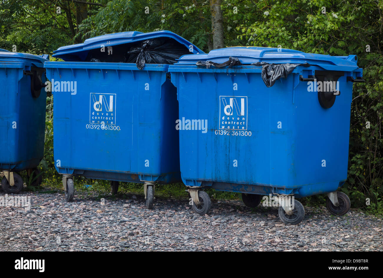 Refuse Wheelie Bins, over filled, black waste bags, Devon, England, UK
