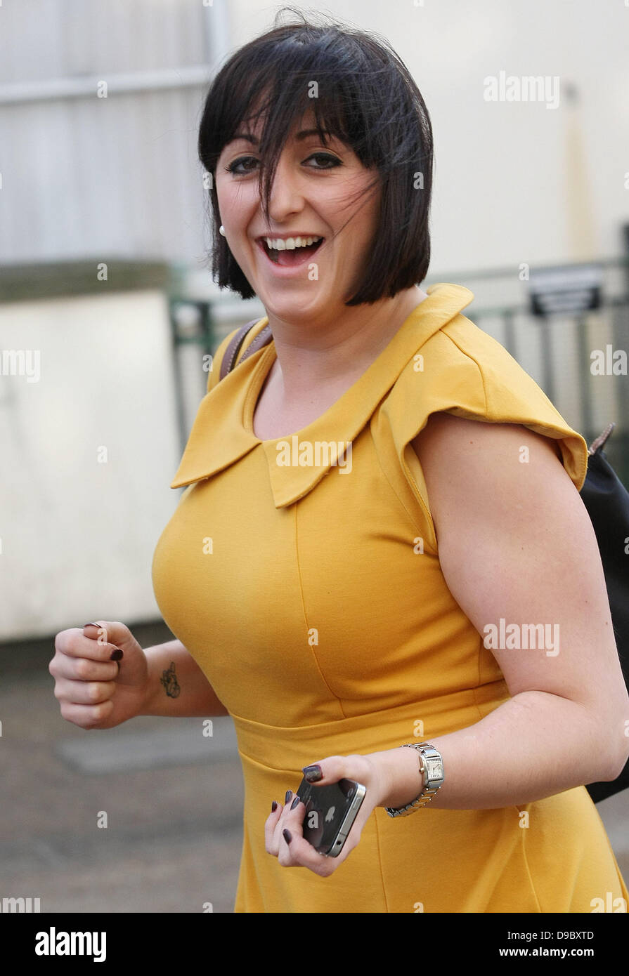 Natalie Cassidy wearing a mustard coloured dress as she leaves a pub at