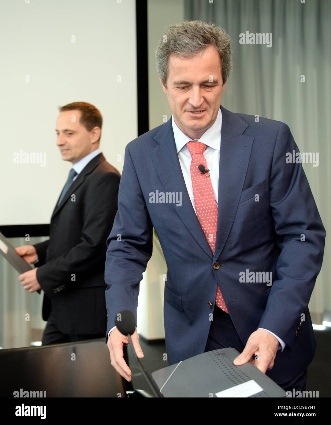 CEO of electric utilities company EnBW, Frank Mastiaux, and CFO Thomas Kusterer (L) enter the conference room before a press conference on Mastiaux's strategy for the future of the company in Stuttgart, Germany, 17 June 2013. Germany's third largest energy company intends to newly align itself. The energy turn and the phasing out of nuclear energy present great challenges to the company. The new CEO Frank Mastieux has to cut costs and to invest at the same time. Photo: BERND WEISSBROD Stock Photo