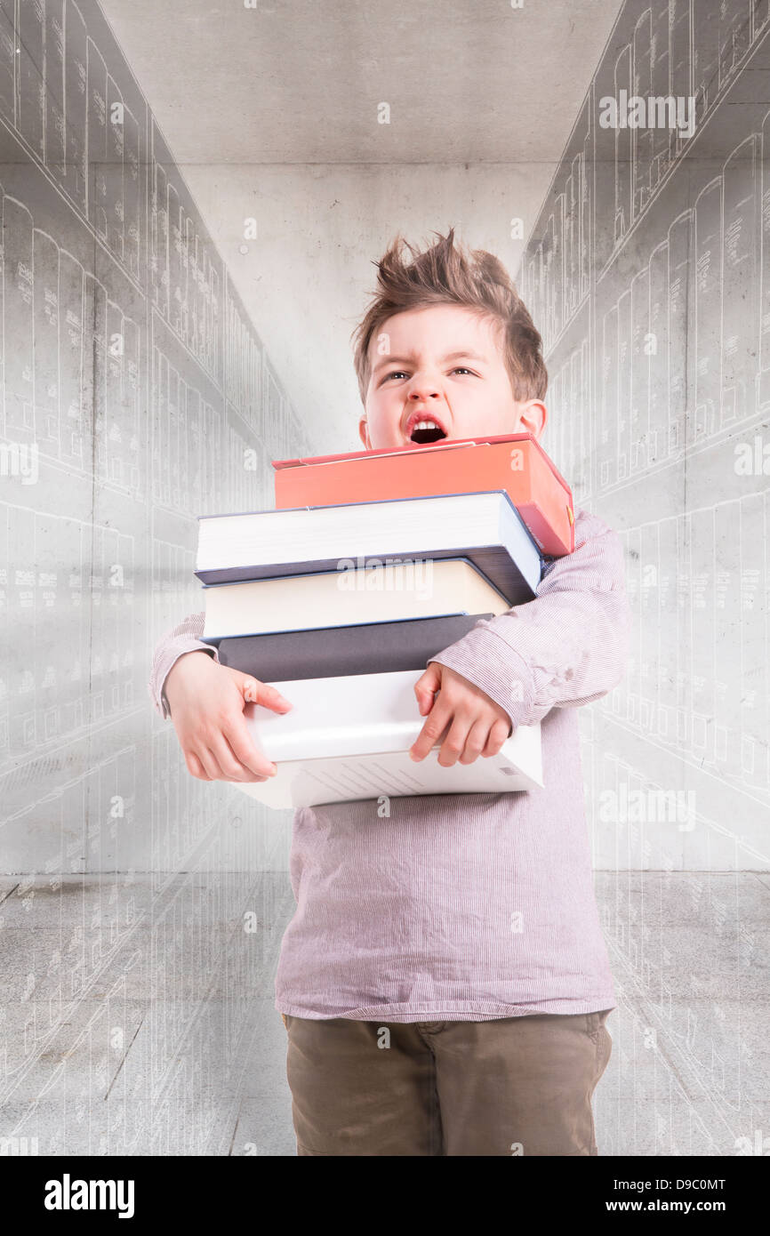 Germany, Brandenburg, Boy holding stack of books Stock Photo - Alamy