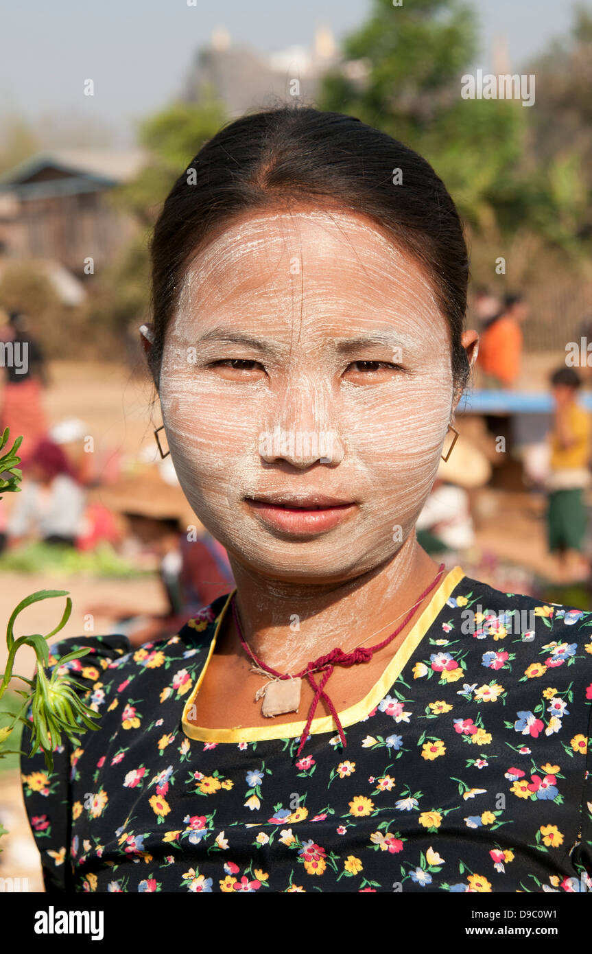 Head and shoulders portrait of a Burmese woman with face covered in thanakha sandalwood paste as makeup Myanmar (Burma) Stock Photo