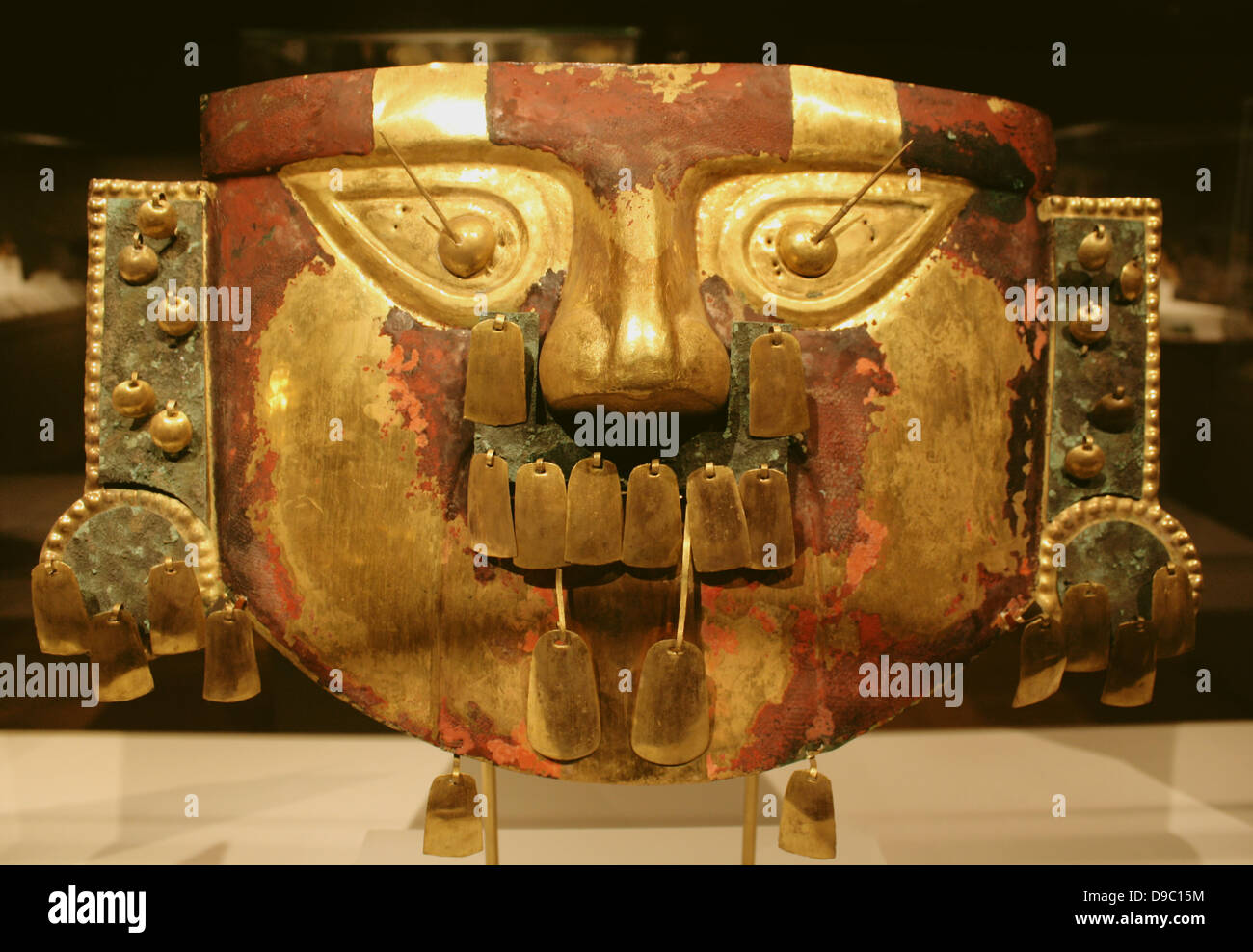 Funerary Mask.  Peru  Sican (Lambayeque) 9th-11th century.  Hammered gold, cinnabar, copper overlays.  The rich tombs of Sican rulers reportedly contained as many as five gold masks along with other precious offerings. Stock Photo