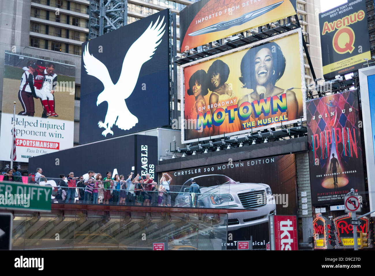 Tourists in Times Square, Midtown, New York. Stock Photo