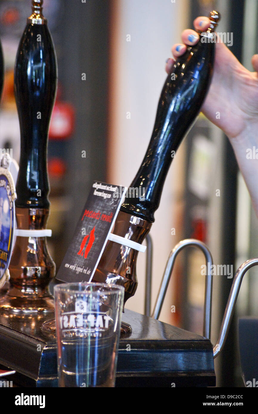 Barmaid pulling a pint of "Peasants' Revolt" red ale by Elephant School