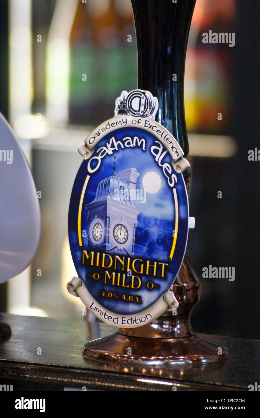 Oakham Ales 'Midnight Mild' pumpclip and handpump in a pub Stock Photo