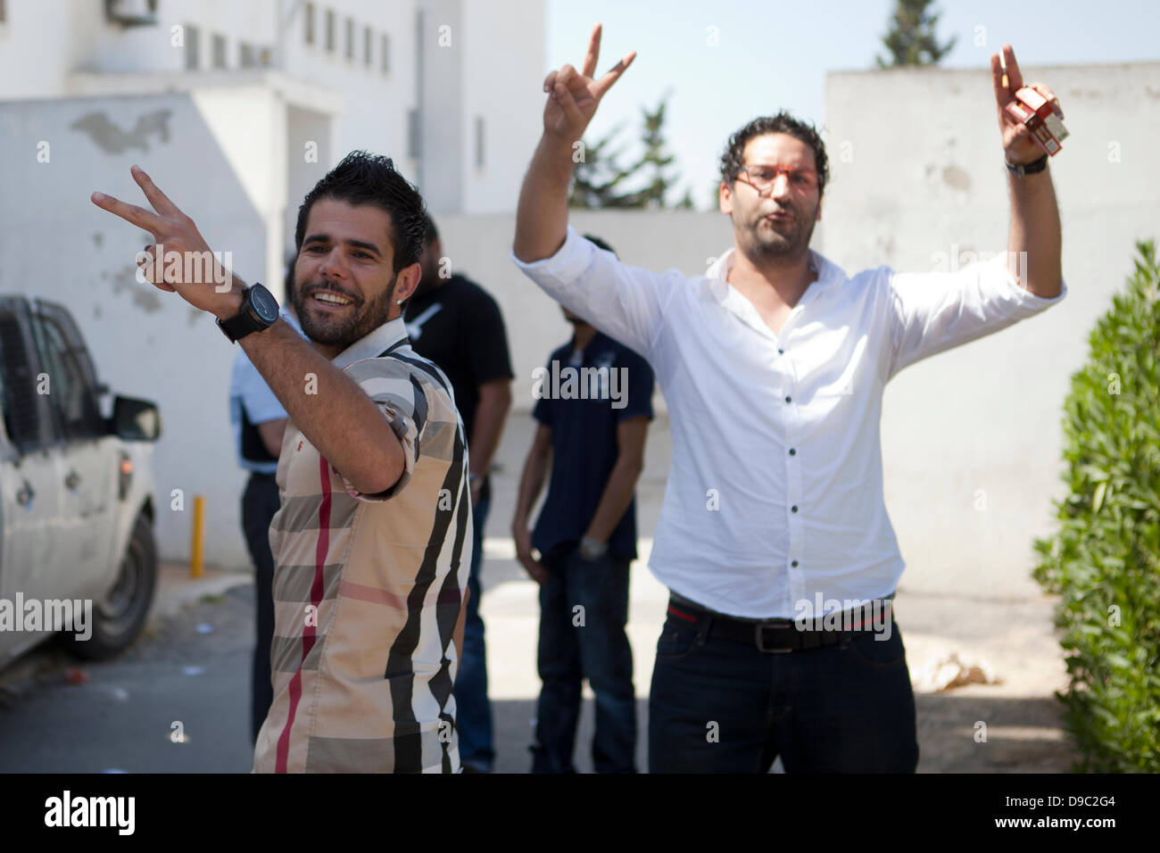 Tunis, Tunisia. 17th June, 2013. Two of the rappers show victory signs before entering the court in Tunis where they face charges for their role in clashes with police after the musician Weld El 15 were sentenced to two years in prison. Credit:  Rey T. Byhre/Alamy Live News Stock Photo