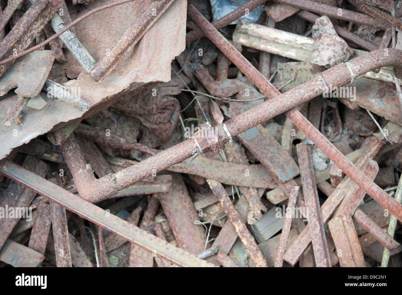 Scrap Rusted Iron Pipe Pipes Rusting Old Pile melt down for recycling Stock Photo