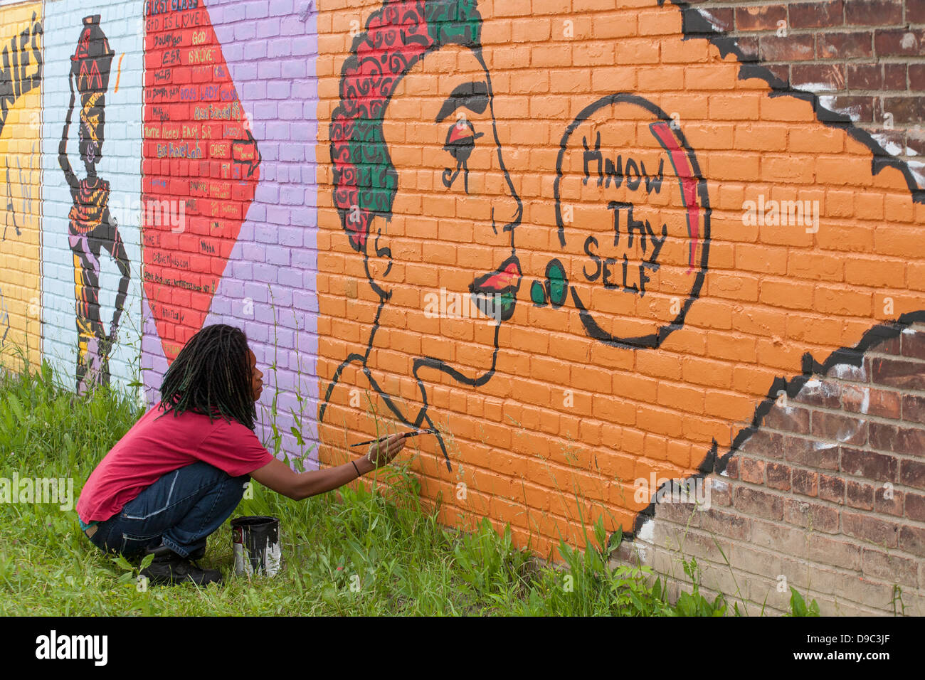 Detroit, Michigan - Volunteers paint a the wall of a grocery store. Stock Photo