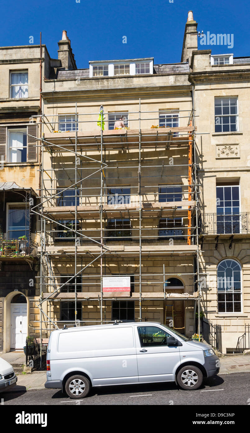 Scaffolding and builders van outside an old house being restored, England, UK Stock Photo