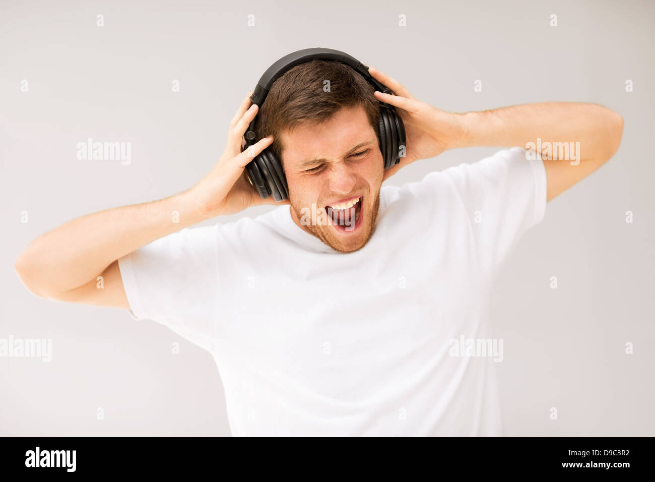 man with headphones listening loud music Stock Photo Alamy