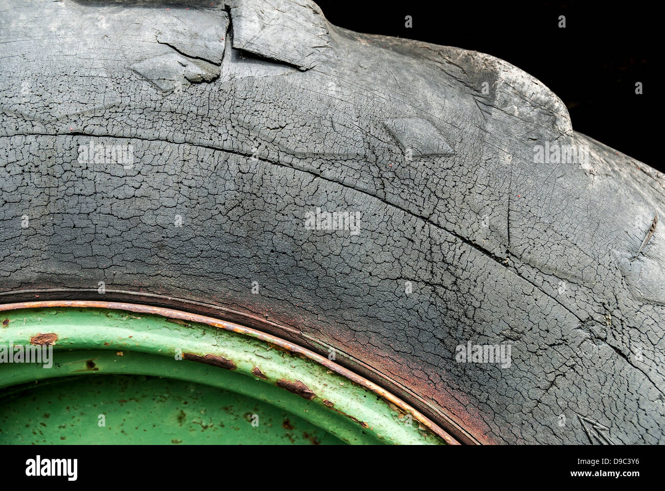 Detail of an old, cracked tractor tire. Stock Photo