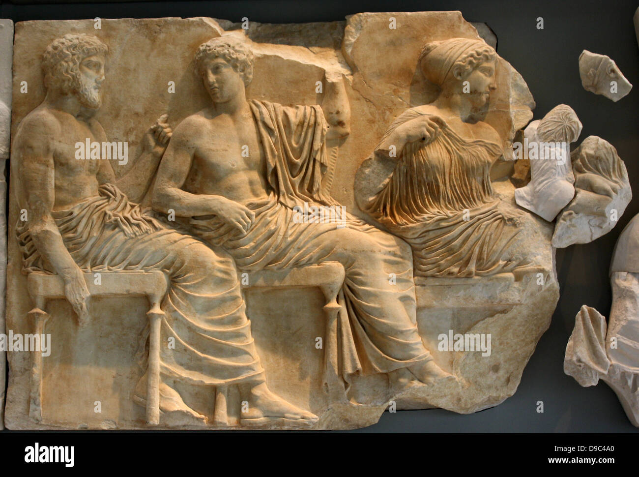 A young winged goddess, Iris or Hebe, messenger of the diving couple Zeus and Hera, stands next to Hera turning toward the procession, while she arranges her wind blown hair with her left hand. Hera turning towards Zeus holds the edges of her himation, which covers her head in the gesture of a bride revealing herself to her husband. Stock Photo