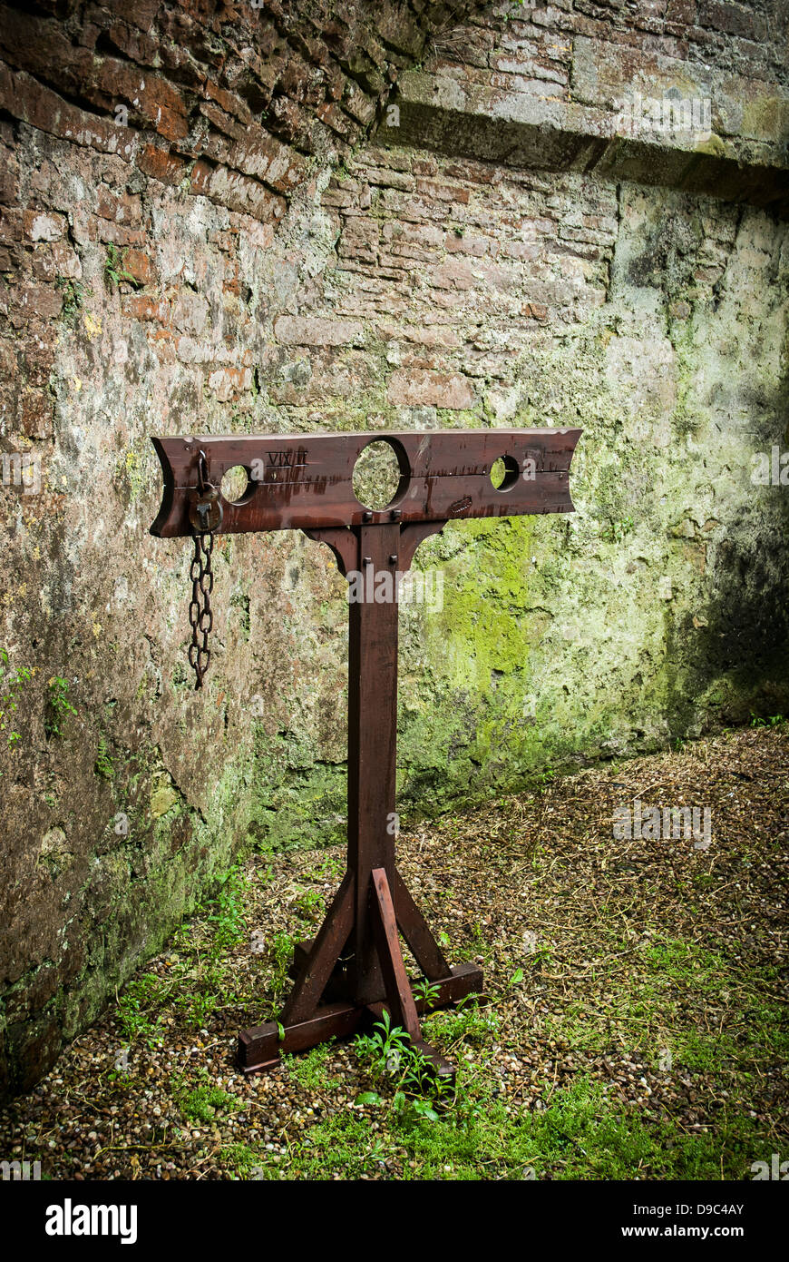 Detail of wooden medieval stocks used to incarcerate criminals in castle grounds. Stock Photo