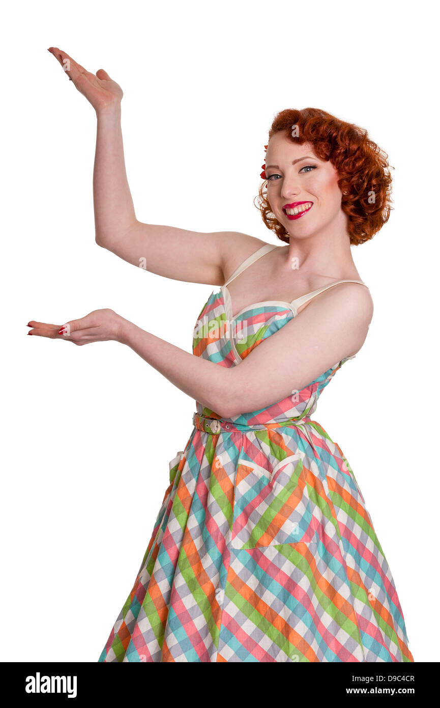 Happy fifties style retro female showing product,  on white Stock Photo