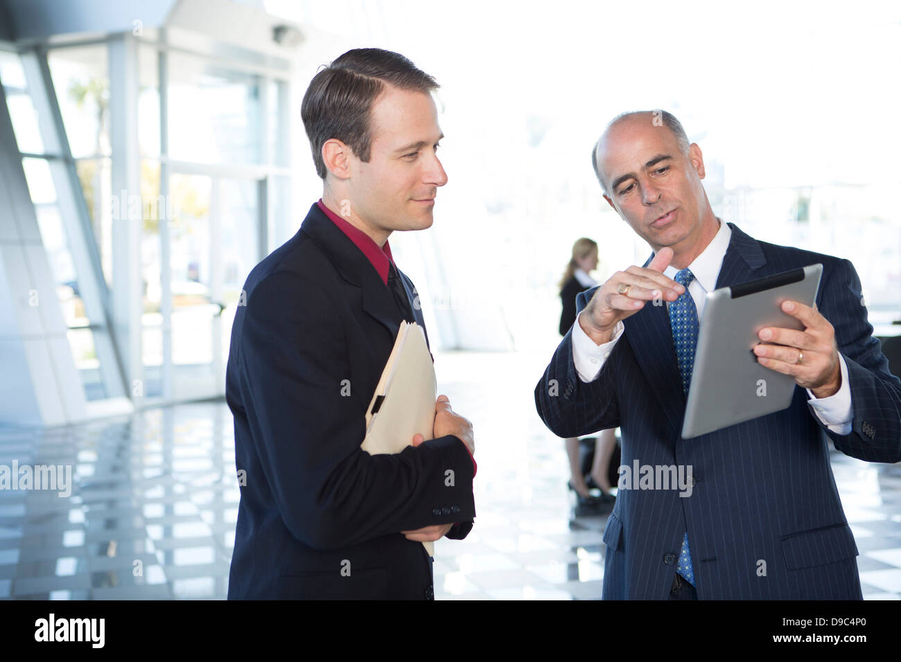 Two businessmen using digital tablet Stock Photo