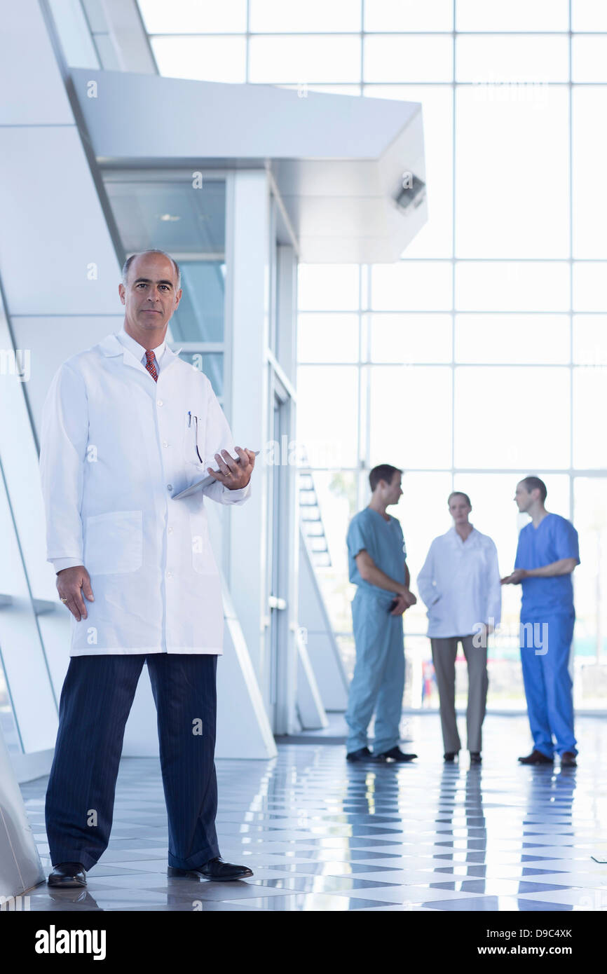 Male doctor holding medical records Stock Photo