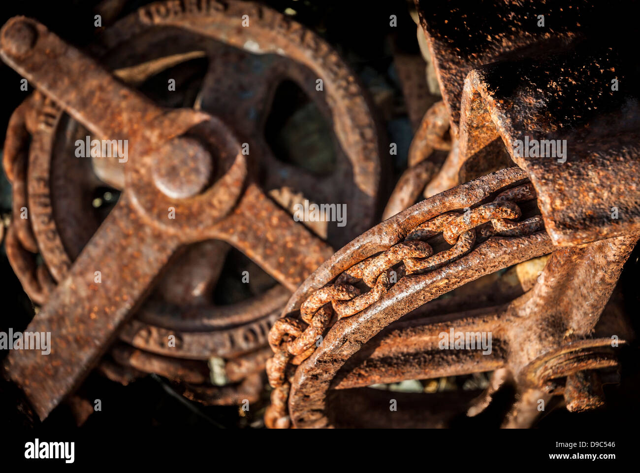 Old industrial rusty chain and pulley detail. Stock Photo