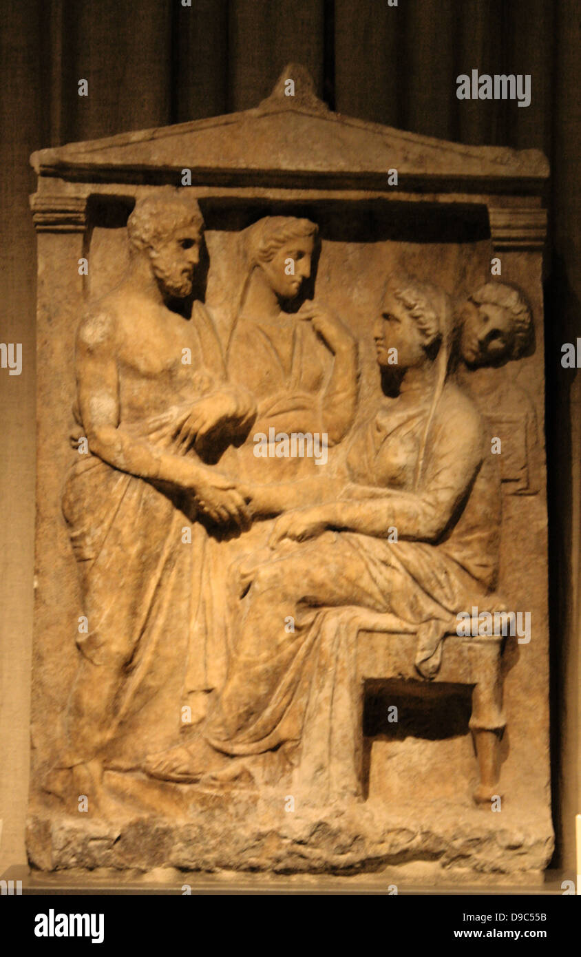 Attic marble grave stele with scene of dexiosis (farewell). The deceased is represented seated and bidding her love ones while the maidservant behind her holds a pyxis. From Keratea, Attica, mid-4th century BC. Stock Photo