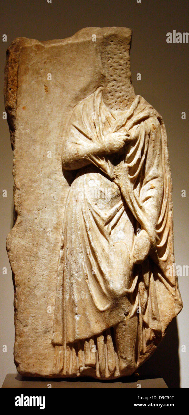 Part of a marble grave relief.  AD 160-180.  Himation-clad female figure, statue of the 'Large Herculaneum woman', a creation associated with the oeuvre of Prazitel. Stock Photo