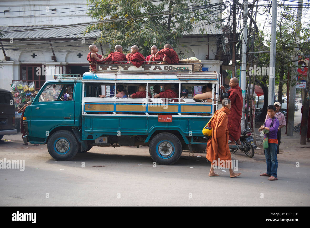 monks boarding a bus Stock Photo