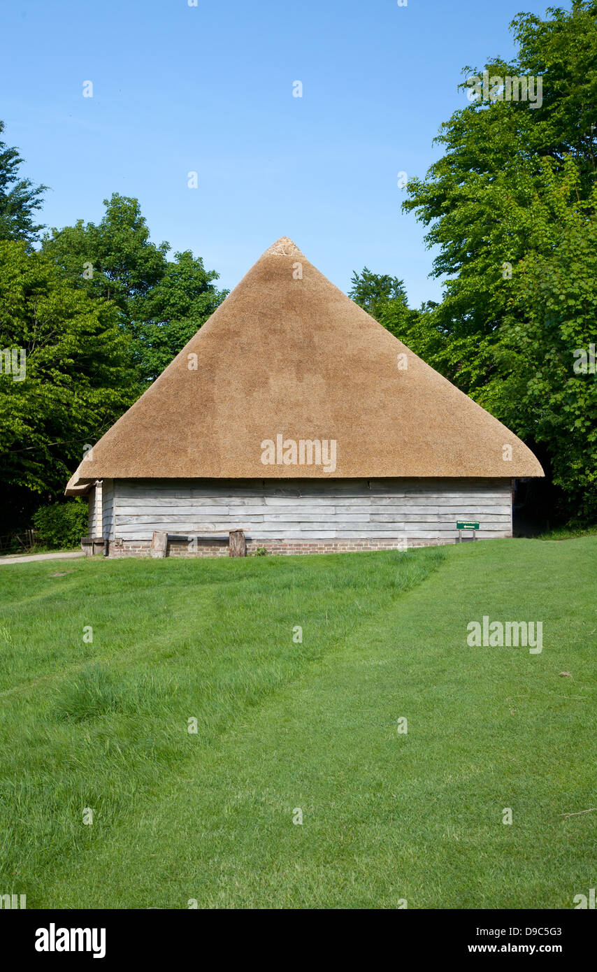 Aisled thatched 18th century timber framed barn (originally from Hambrook, Sussex) on a summer's day - as seen on BBC The Repair Shop Stock Photo