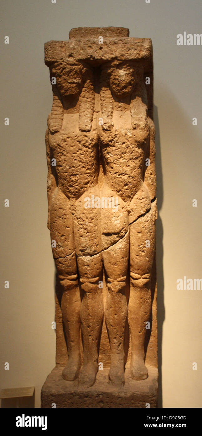 Grave stele. Boeotian poros.  Found at Tanagra in Boeotia.  This unusual stele, one of the earliest known funerary monuments was erected by Amphalkes on the grave of Dermys and Kitylos, as recorded in the inscription.  The two dead youths, possibly brothers, are shown embracing one another.  Dermys stands on the left, Kitylos on the right.  At top, the stele would have been crowned originally by a seated Sphinx.  First quarter of the 6th century BC. Stock Photo