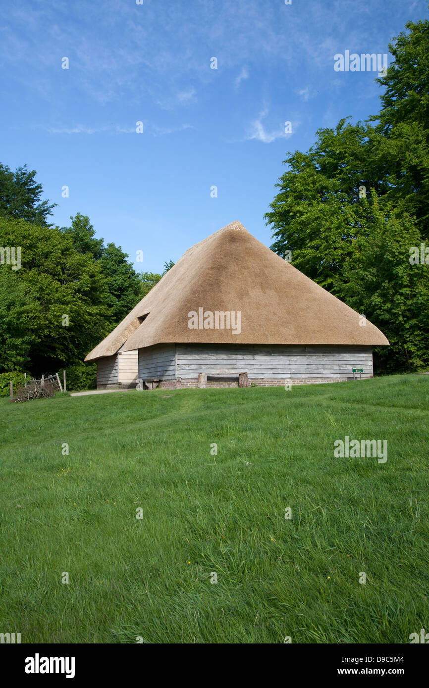 Aisled thatched 18th century timber framed barn (originally from Hambrook, Sussex) on a summer's day - as seen on BBC The Repair Shop Stock Photo