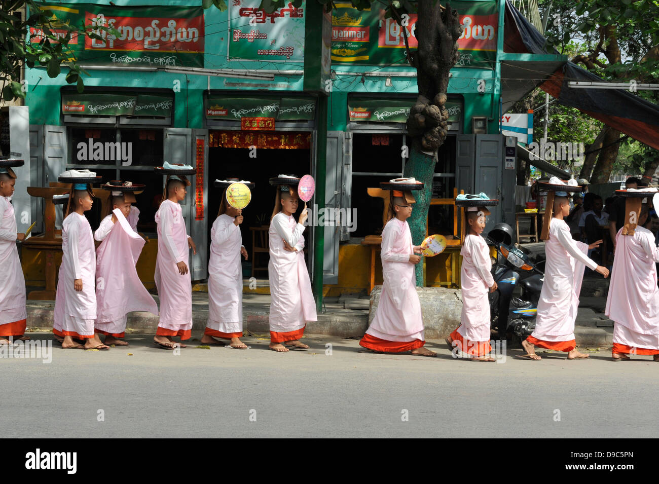walking in line in the streets of Mandalay Stock Photo
