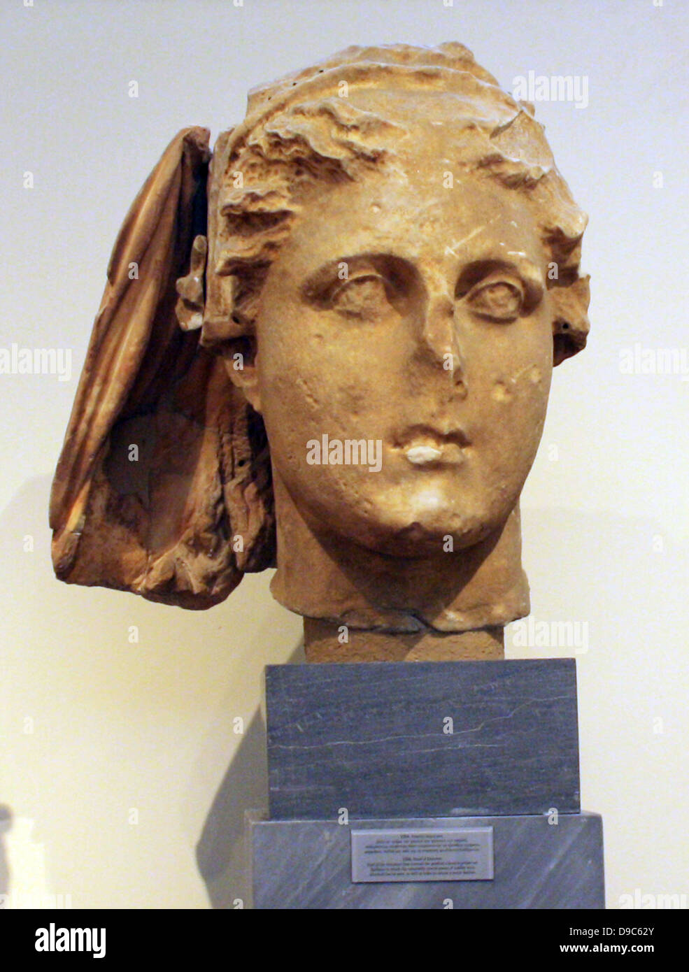 Head of Demeter.  Part of the himation that covered the goddess's head is preserved.  Surfaces to which separately carved pieces of marble were attached as well as holes to secure a metal diadem can be seen. Stock Photo