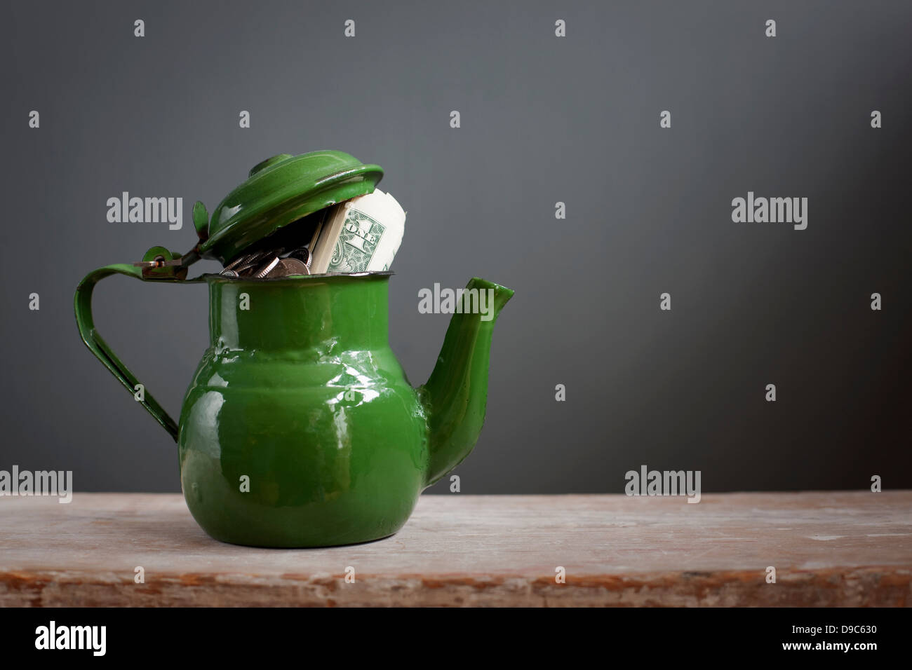 Teapot with dollar notes inside Stock Photo Alamy
