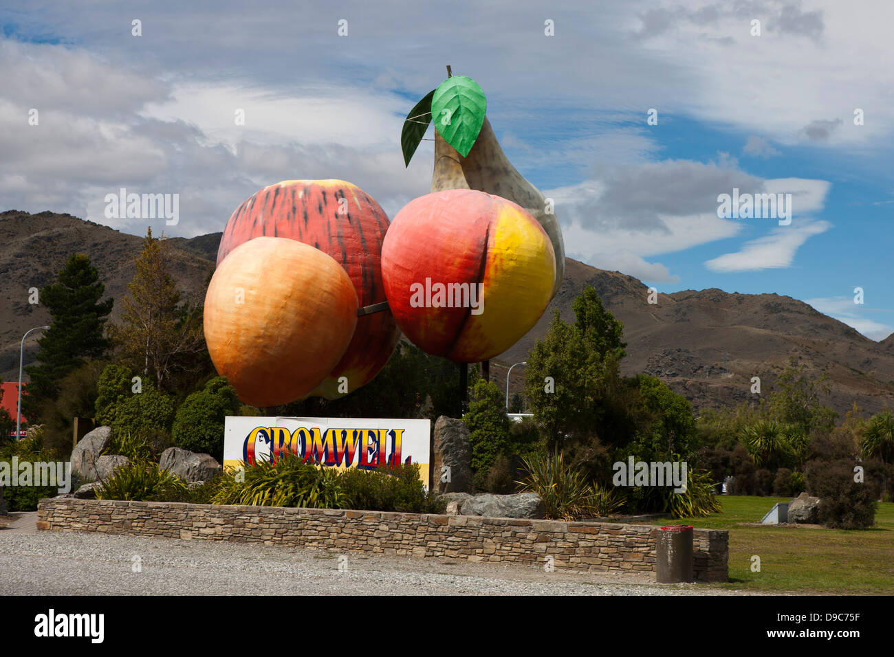 Sculpture of large pieces of fruit with a sign, Cromwell, South Island, New Zealand Stock Photo