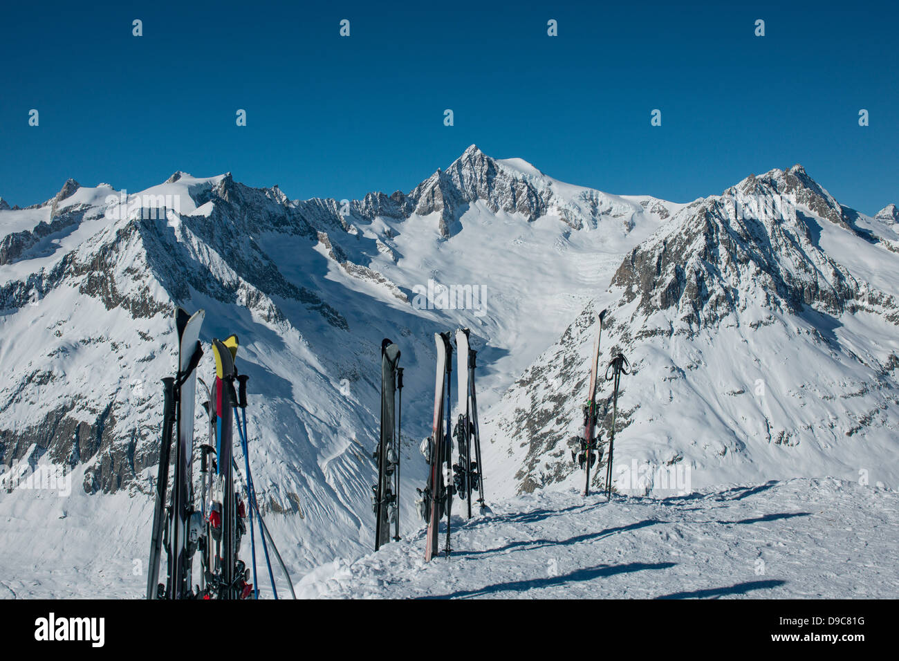 Skis standing in snow in mountains Stock Photo