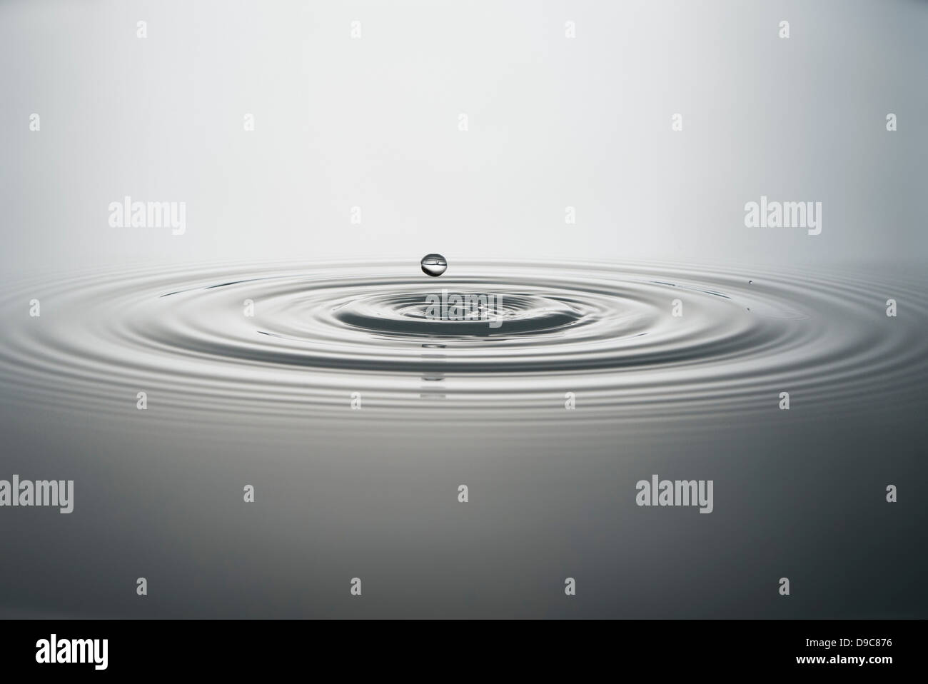 Water droplet falling into water Stock Photo Alamy