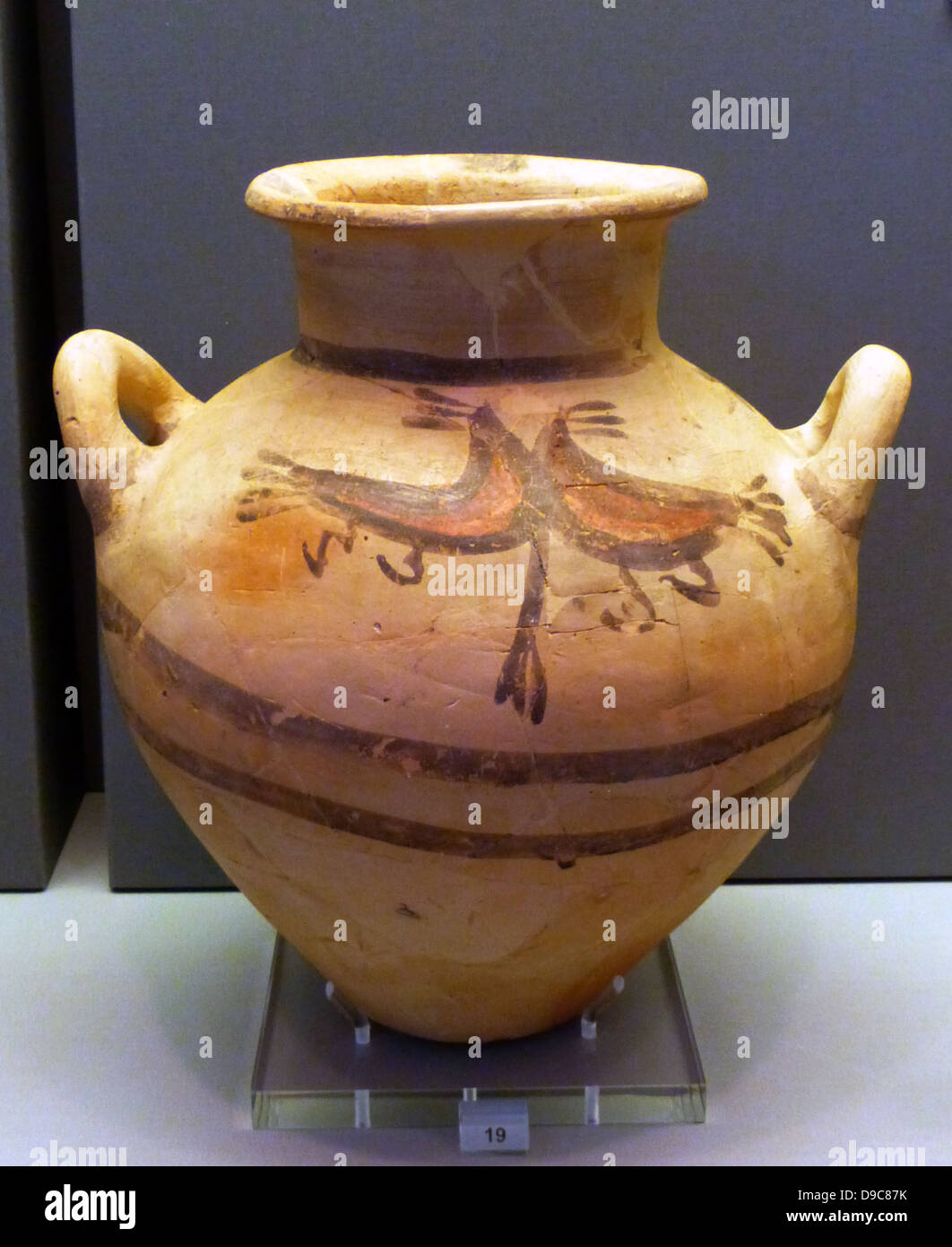Small clay jar and clay jug of Cycladic type with bichrome decoration of birds and circles respectively. Stock Photo
