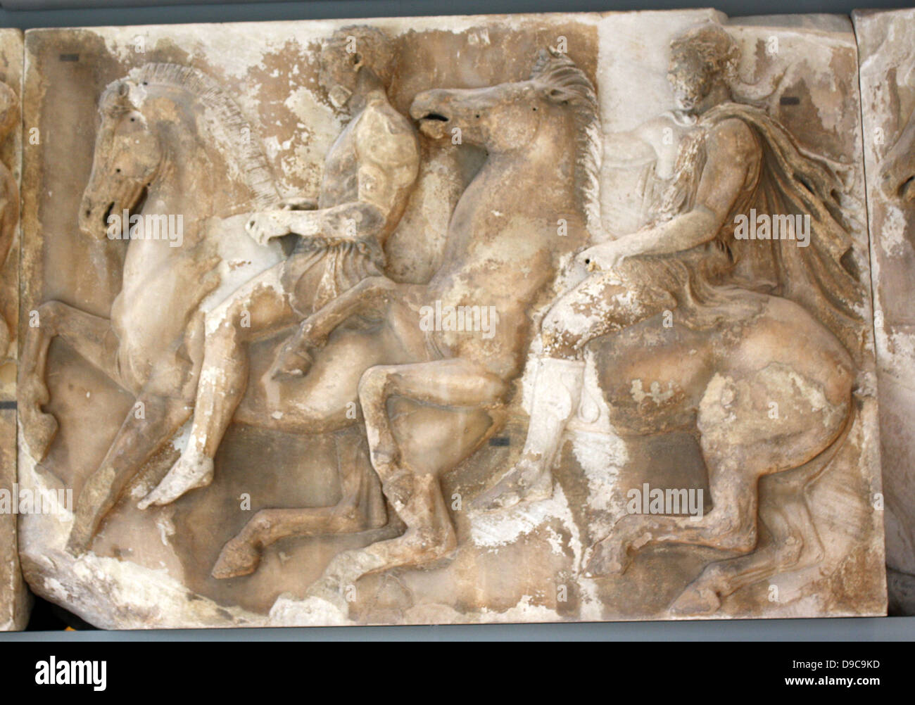 Section of the Parthenon frieze is the low relief, Pentelic marble sculpture created to adorn the upper part of the Parthenon’s naos. It was sculpted between ca. 443 and 438 BC, under the direction of Phidias. Acropolis Museum, Athens, Greece. Stock Photo