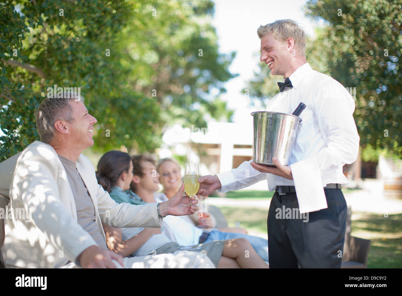 Waiter Serving Customers In Garden Stock Photo 57434246 Alamy