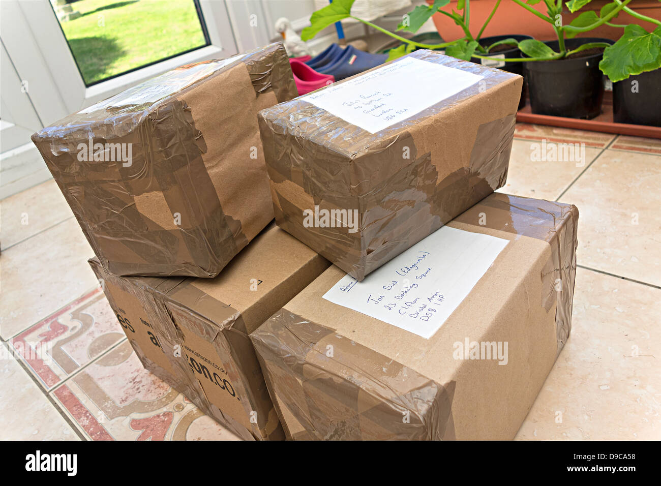 Parcels, boxes stacked up on the floor ready for delivery. Stock Photo