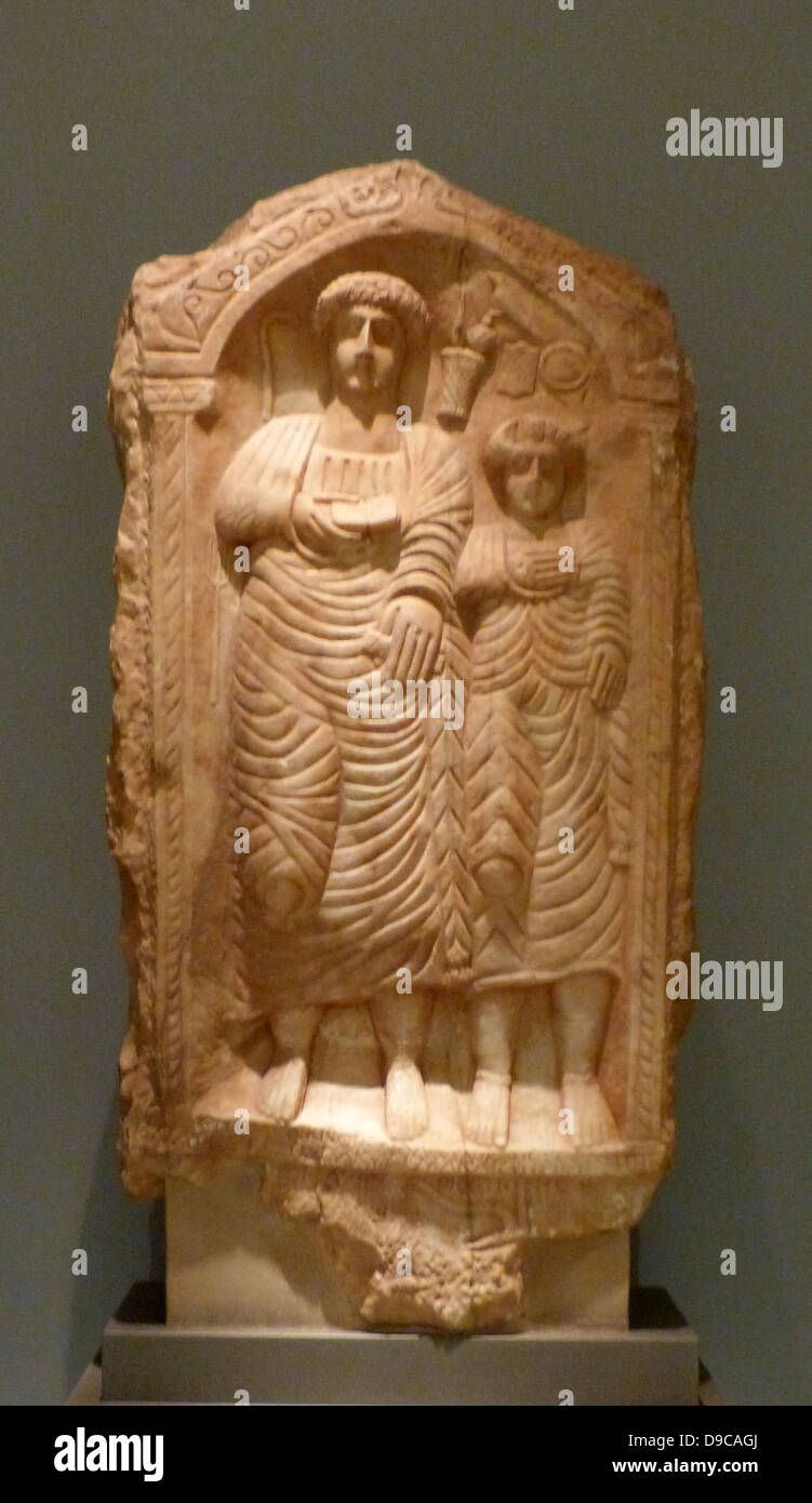 Marble inscribed grave relief. Represented is a couple in an arched ...