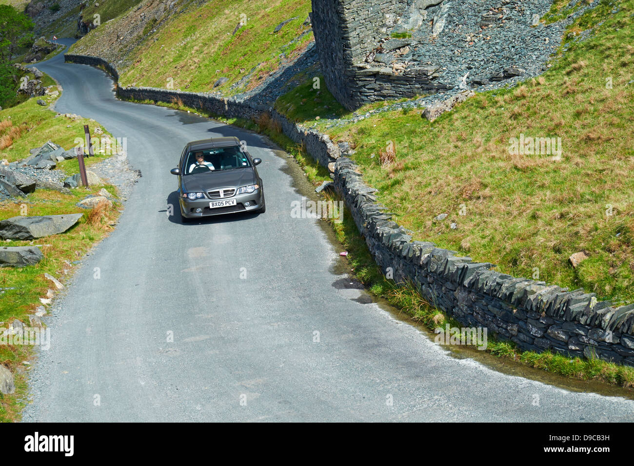 A car driving up Honister Pass near Buttermere in the Lake District Stock Photo