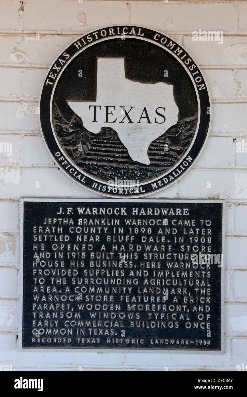 J. F. WARNOCK HARDWARE Jeptha Franklin Warnock came to Erath County in 1898 and later settled near Bluff Dale. In 1908 he opened a hardware store and in 1915 built this structure to house his business. Here Warnock provided supplies and implements to the surrounding agricultural area. A community landmark, the Warnock Store features a brick parapet, wooden storefront, and transom windows typical of early commercial buildings once common in Texas. Recorded Texas Historic Landmark - 1984 Stock Photo