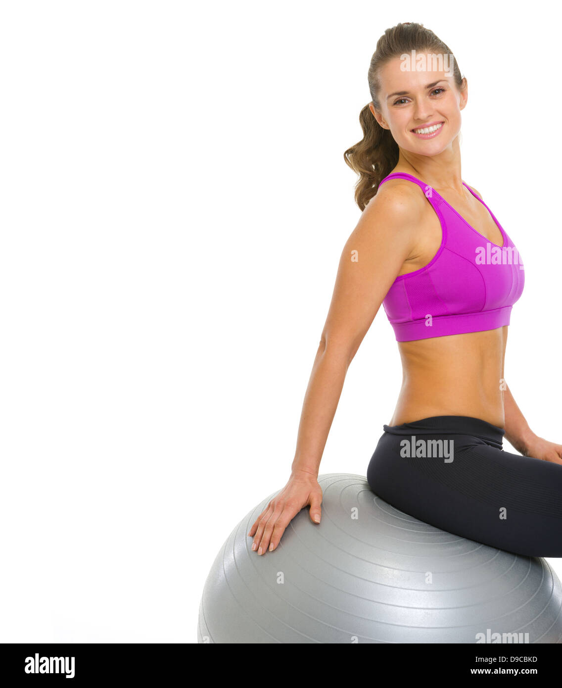 Happy young woman sitting on fitness ball Stock Photo - Alamy