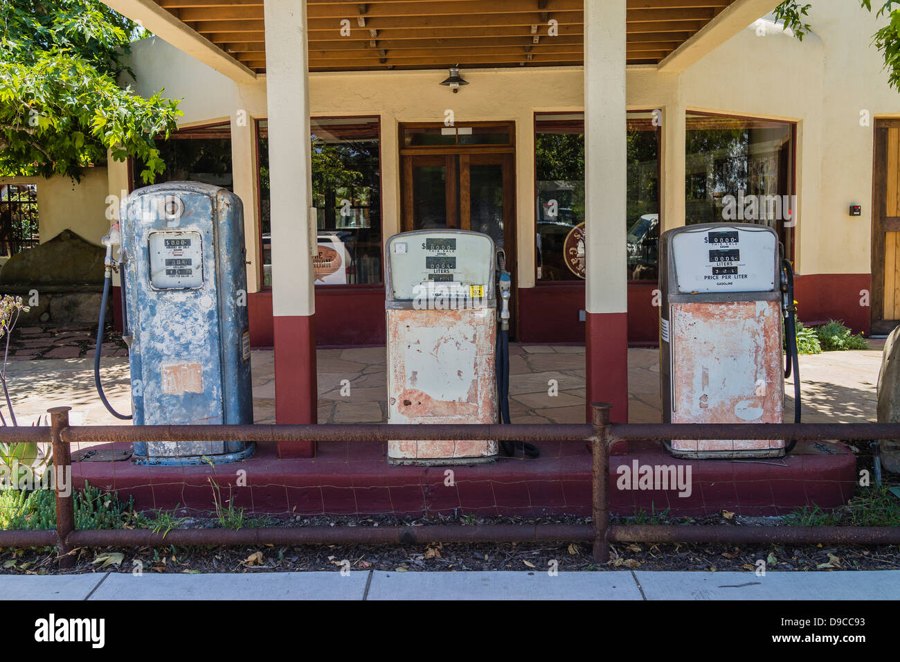 The front of three well-weathered old fashioned gasoline pumps in Los Alamos, California. Stock Photo