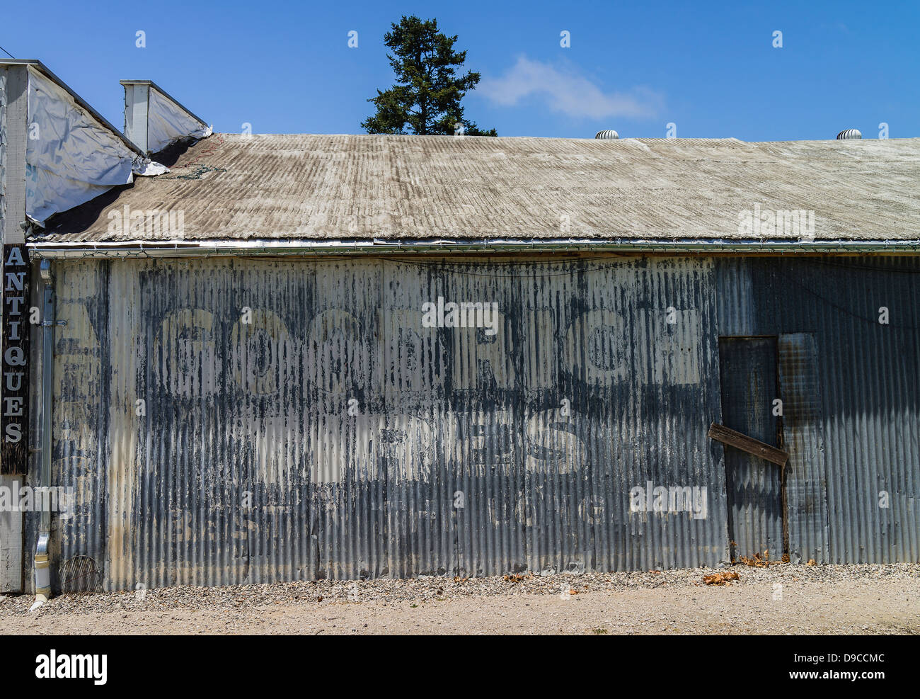 The exterior of an antique store located in an old false front building with weathered steel siding. Stock Photo