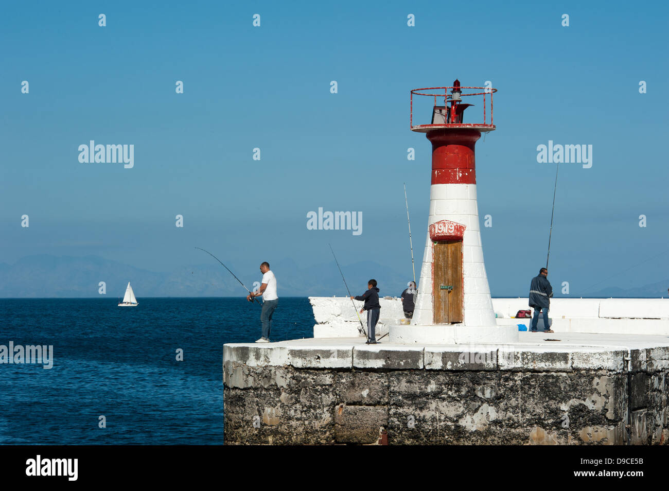 Fishermen at the lighthouse, Kalk Bay, False Bay, South Africa Stock Photo