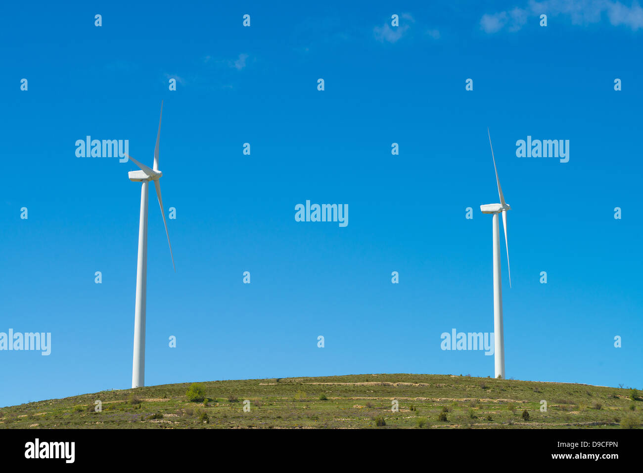 Wind turbines against a sunny blue sky Stock Photo - Alamy